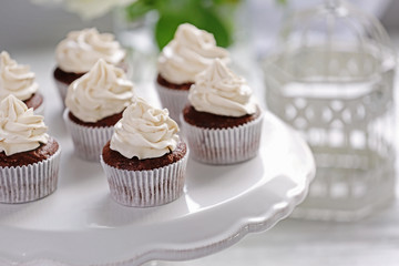 Tasty cupcakes on stand