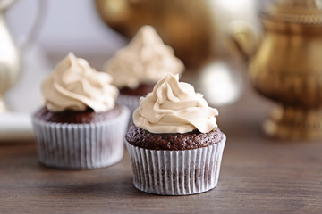 Tasty cupcake on wooden table