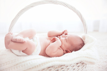 Newborn baby girl, 7 days old, sleeping on soft fluffy blanket
