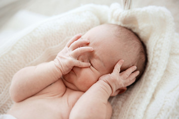 Newborn baby girl, 7 days old, sleeping on soft fluffy blanket