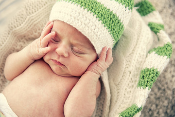 Newborn baby girl, 7 days old, sleeping on soft blanket