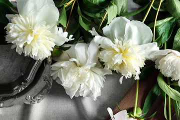 Naklejka na ściany i meble Composition with beautiful peony flowers on white fabric, top view
