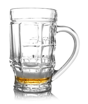 Almost empty beer glass, isolated on white