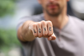 Man fist with fake tattoo