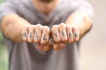 Man fists with fake tattoo