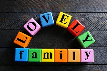 Color words LOVELY FAMILY on wooden background