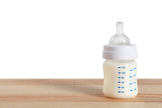 Baby milk bottle on wooden table
