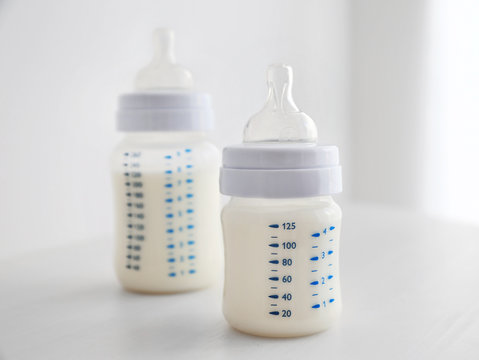 Baby milk bottles on white background