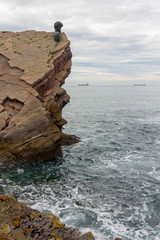 Monument on the rocks by the sea of Philippe Cousteau, Gijon, spain