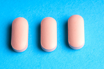 Many pills and tablets isolated on light blue background