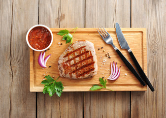 Beef steaks on wooden background