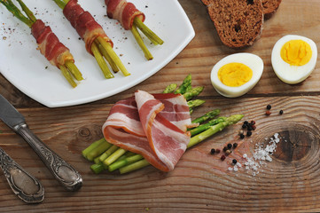 asparagus with bacon on vintage wooden background