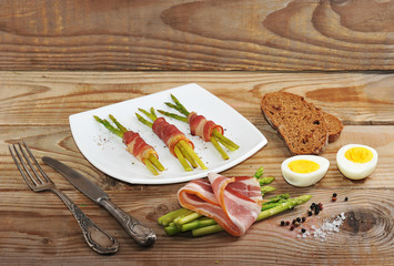 asparagus with bacon on vintage wooden background