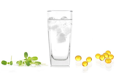 glass of water and Cod liver oil  isolated on white