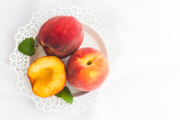 Fresh peaches on white background, top view, flat lay