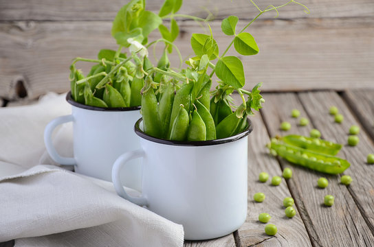 Fresh green peas on rustic wooden background, selective focus