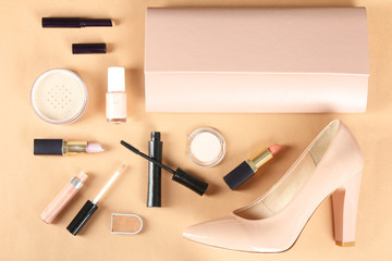 female cosmetics with cosmetic bag on a peach background