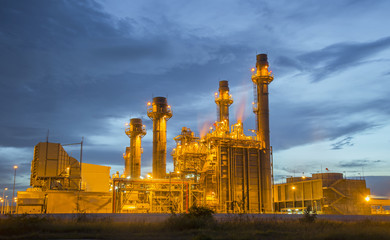 Oil refinery plant at twilight with sky background
