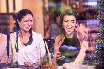 Young beautiful women with cocktails in bar or club