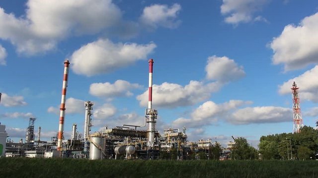 Oil refinery in sunny beautiful weather with clouds in background