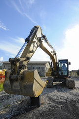 Excavator shovel at construction site by building a road.
