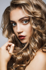 Beautiful girl with long wavy hair . fair-haired model with curl
