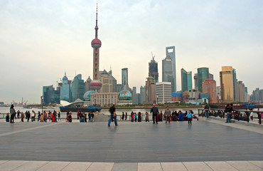 Shanghai, tourists in the Bund and Pudong skyline in the bottom. 