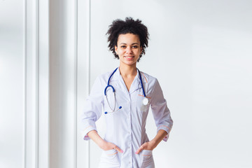 Doctor with stethoscope around his neck looking at the camera smiling