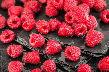 Fresh red raspberries on a slate background