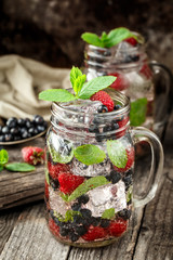 Detox drink with fresh berries in glass jars
