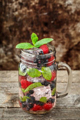 Detox drink with fresh berries in glass jars