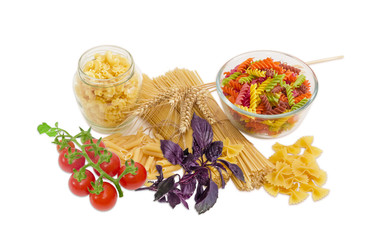 Several different uncooked pasta, wheat spikes, basil, cherry to