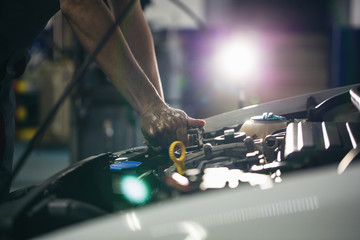 Auto mechanic repair engine in a car repair shop