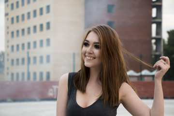 Beautiful girl in grey dress on the roof