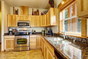 Nicely decorated kitchen room interior with modern cabinets and tile floor