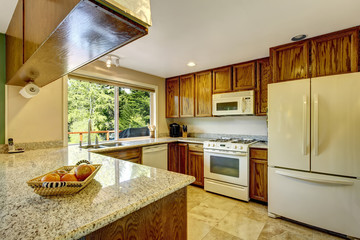 View of kitchen room with hardwood cabinets and tile flooring