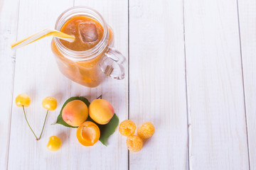 a cold drink smoothie with cherry apricot and raspberry is on a