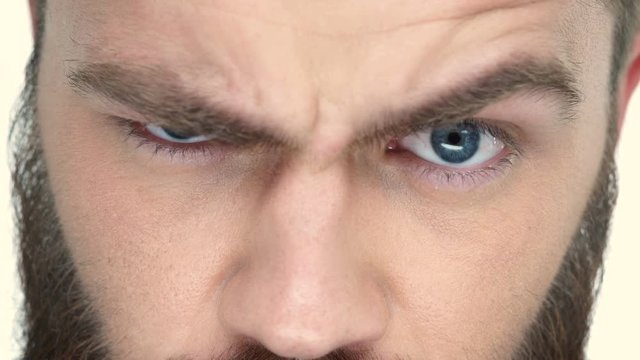 Young handsome bearded man moves his eyebrows 