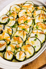 Casserole with zucchini, cheese and fresh basil in baking dish