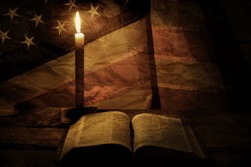 Obraz na płótnie Canvas Old american flag and candle. Burning candle near a book. Wisdom comes with time. Learn the right things.