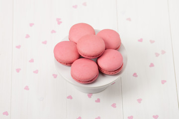 Macaroons Biscuits On White Stand. Paper Hearts