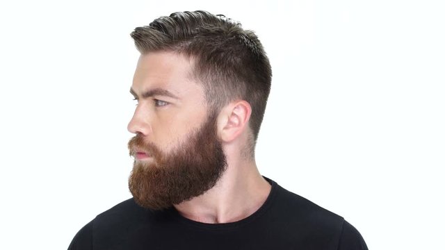 Young handsome bearded man moves his head right and left