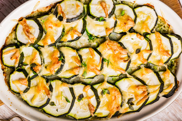 Casserole with zucchini, cheese and fresh basil in baking dish