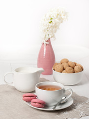 Hyacinth Flowers In Vase. Amaretti Biscuits. Cup Of Tea