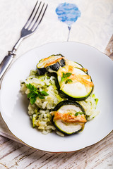 Casserole with zucchini, rice and cheese served with fresh basil