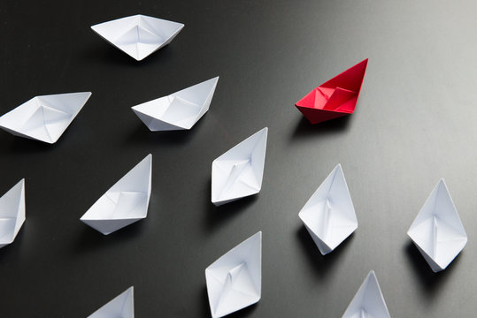 Leadership concept illustrated with paper ships