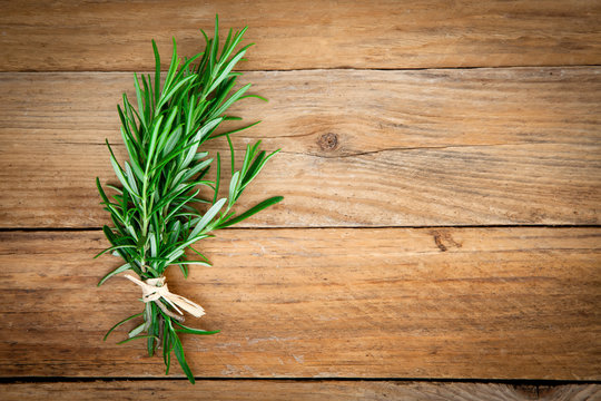 Rosemary bound on a wooden background.
