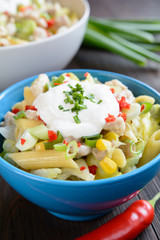 Pasta salad with fried chicken meat and vegetable