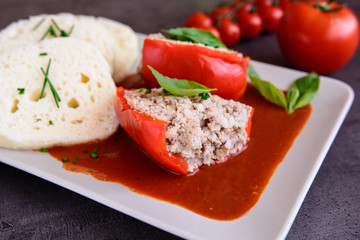 Red pepper stuffed with rice, minced meat and vegetable in tomato sauce with steamed dumpling