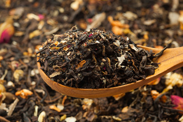Close up of dry tea in wooden spoons.Selective focus on blurry background
